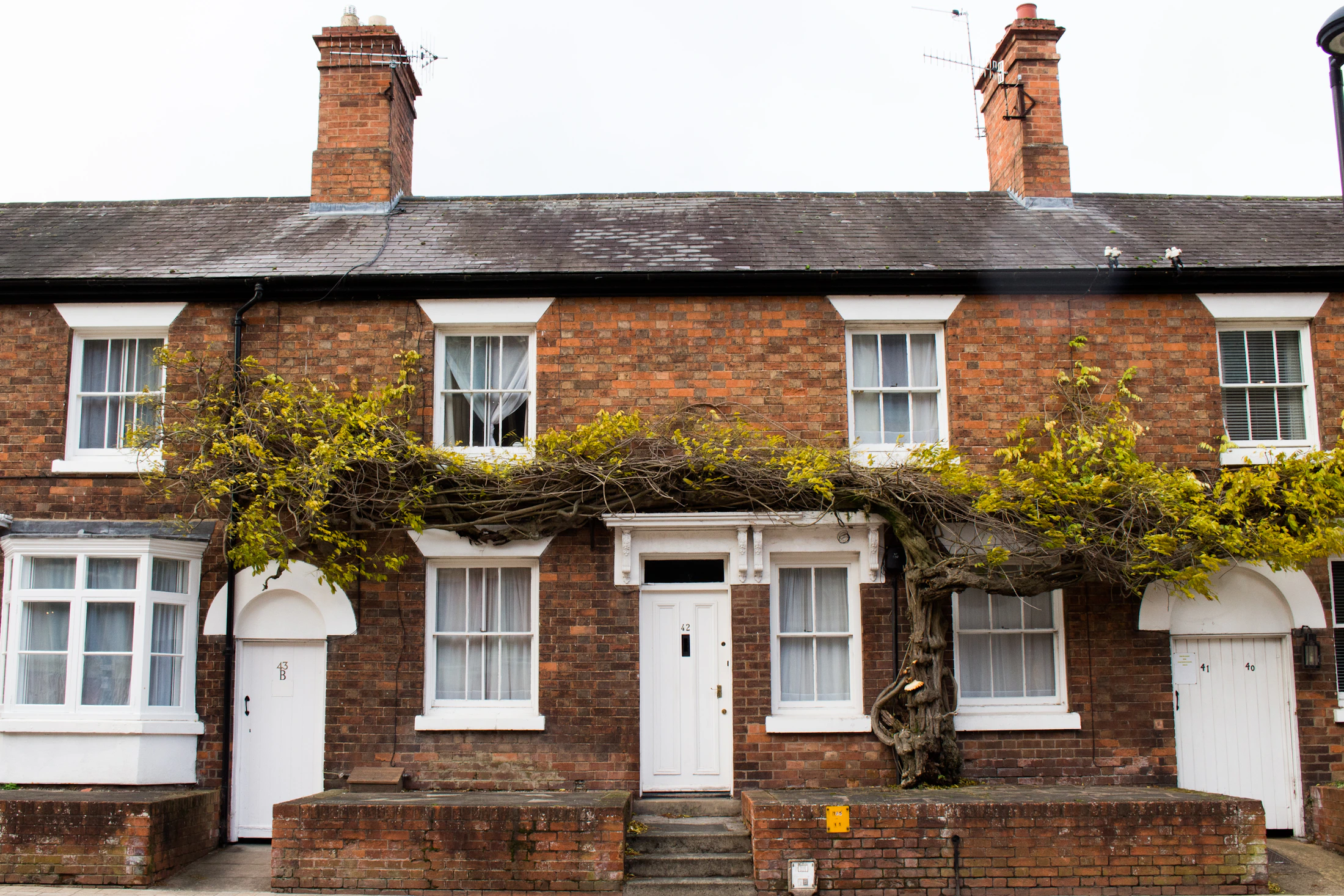 Traditional British brick terrace with slate roof and chimney stacks